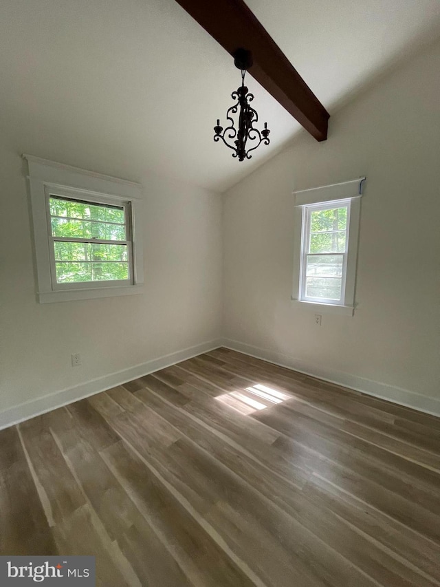 empty room featuring an inviting chandelier, dark hardwood / wood-style flooring, and lofted ceiling with beams