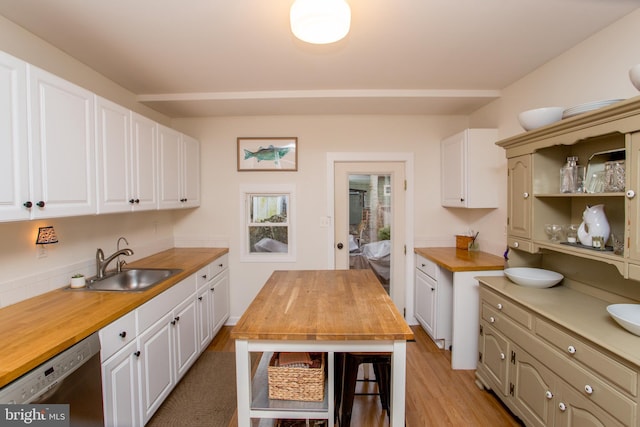 kitchen with white cabinets, wooden counters, black dishwasher, light hardwood / wood-style floors, and sink