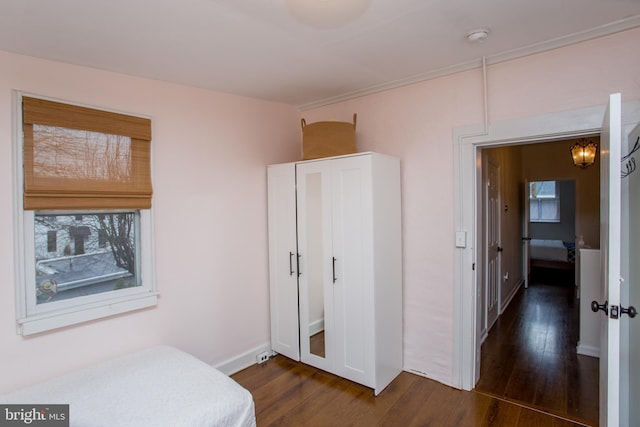 bedroom with dark wood-type flooring