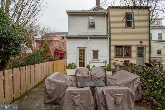 rear view of property featuring an outdoor living space and a patio