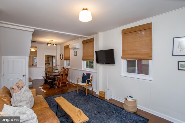 living room featuring dark hardwood / wood-style floors and a wall unit AC