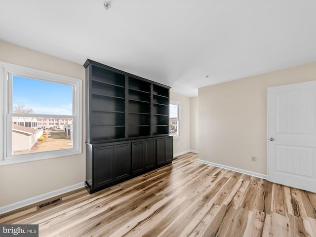 unfurnished room with light hardwood / wood-style flooring