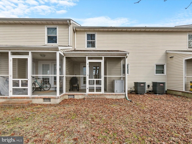 back of house with a patio area, a sunroom, and central air condition unit