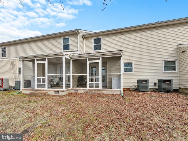 rear view of house with a sunroom and central air condition unit