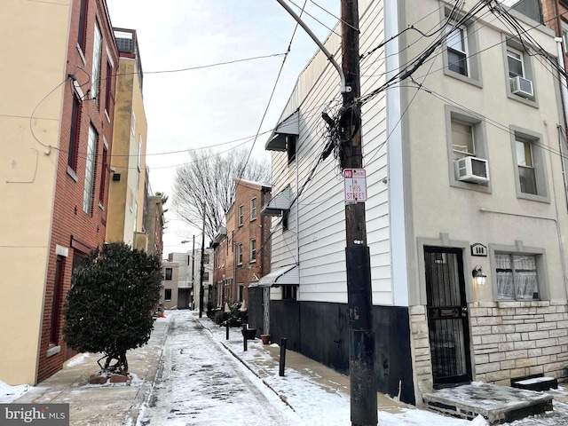 snow covered property featuring cooling unit