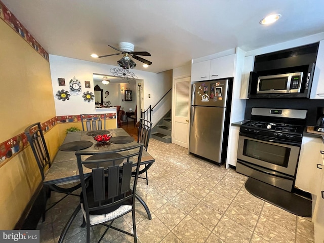 kitchen featuring white cabinetry, ceiling fan, and stainless steel appliances