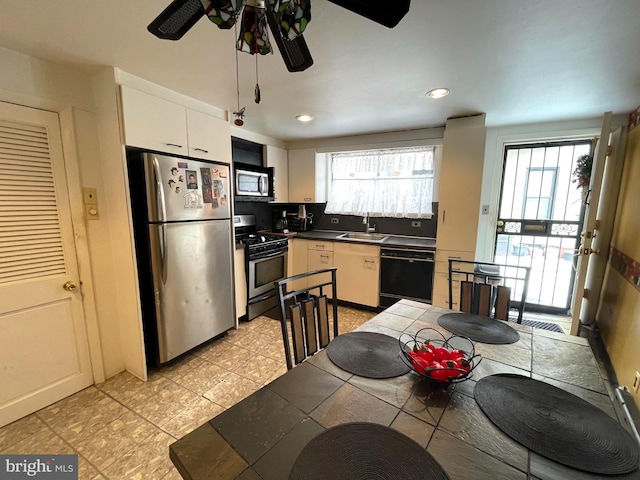 kitchen with sink, white cabinetry, appliances with stainless steel finishes, and plenty of natural light