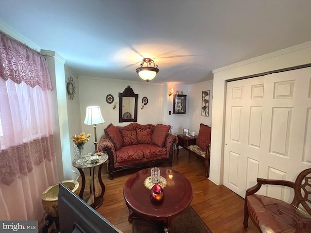 living room with ornamental molding and dark hardwood / wood-style floors