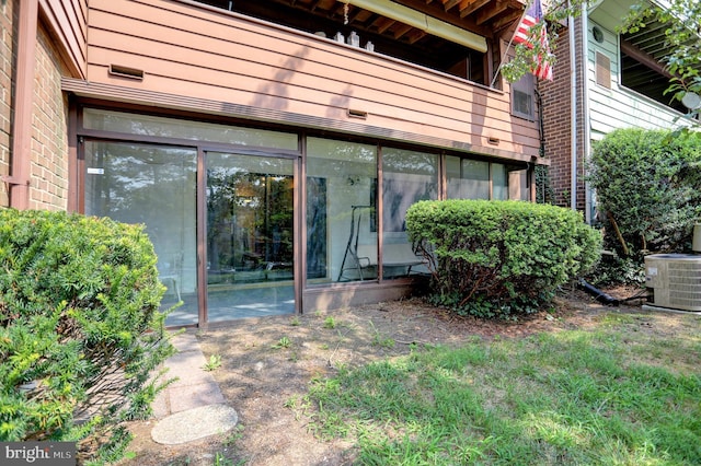 doorway to property featuring a balcony and central AC unit