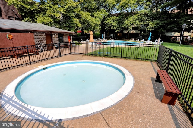 view of pool featuring a lawn