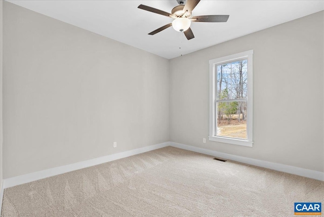 carpeted spare room featuring ceiling fan