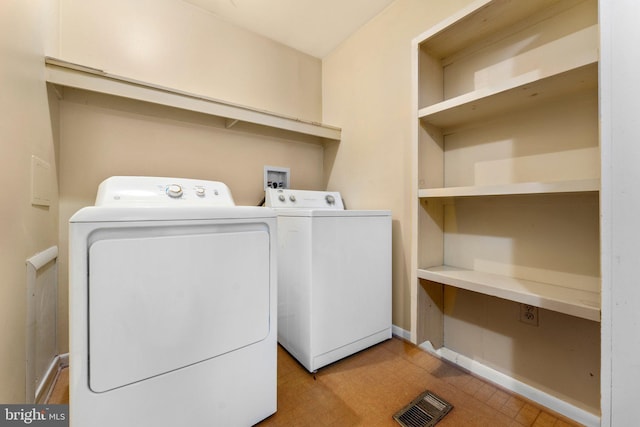 clothes washing area with washing machine and clothes dryer