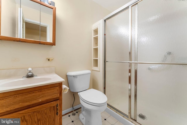 bathroom with tile patterned flooring, vanity, an enclosed shower, and toilet