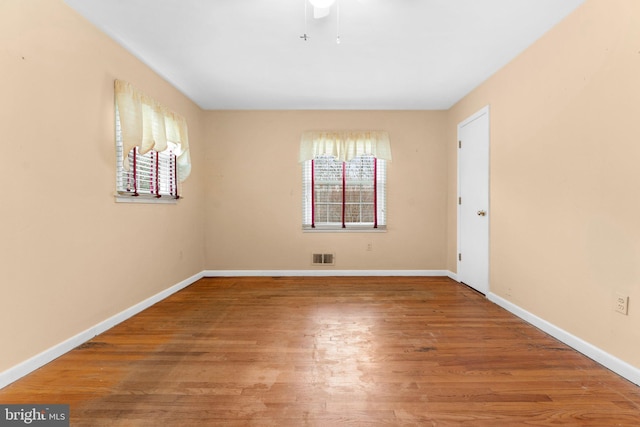 empty room with hardwood / wood-style flooring