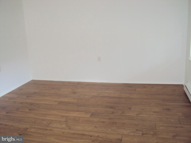 unfurnished room with dark hardwood / wood-style flooring