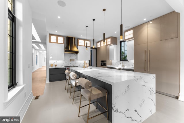 3819 NW Albemarle St NW, Washington, DC 20016 - kitchen featuring wall chimney exhaust hood, modern cabinets, decorative backsplash, recessed lighting, and a large island