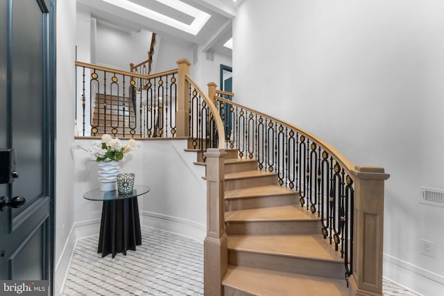 3819 NW Albemarle St NW, Washington, DC 20016 - staircase featuring a skylight and a towering ceiling