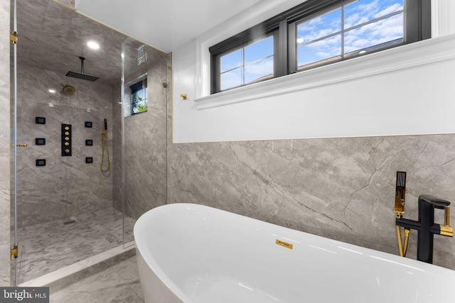 3819 NW Albemarle St NW, Washington, DC 20016 - full bathroom featuring a soaking tub, tile walls, marble look tile flooring, and a tile shower