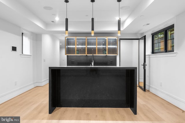 3819 NW Albemarle St NW, Washington, DC 20016 - kitchen with light wood finished floors, a raised ceiling, pendant lighting, and a center island