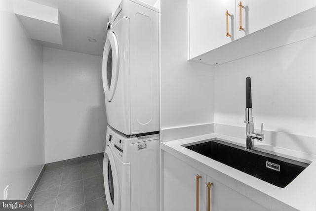 3819 NW Albemarle St NW, Washington, DC 20016 - washroom with stacked washer / dryer, cabinet space, and tile patterned flooring