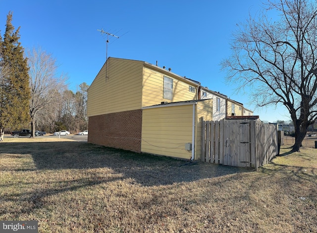 view of side of home with a yard