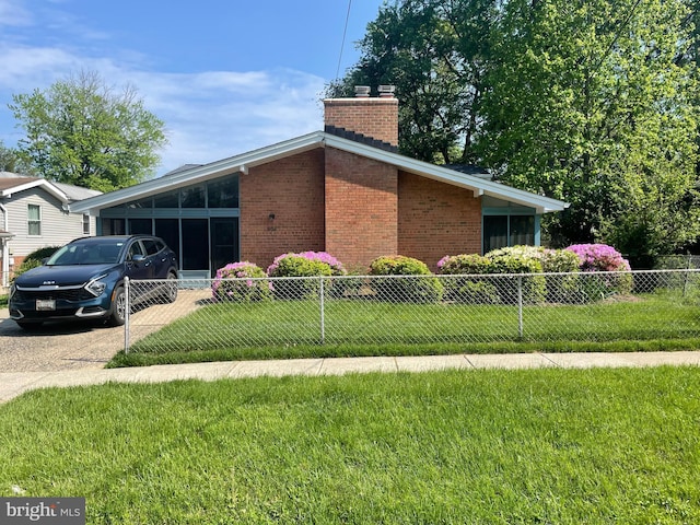 view of property exterior with brick siding, a chimney, and driveway