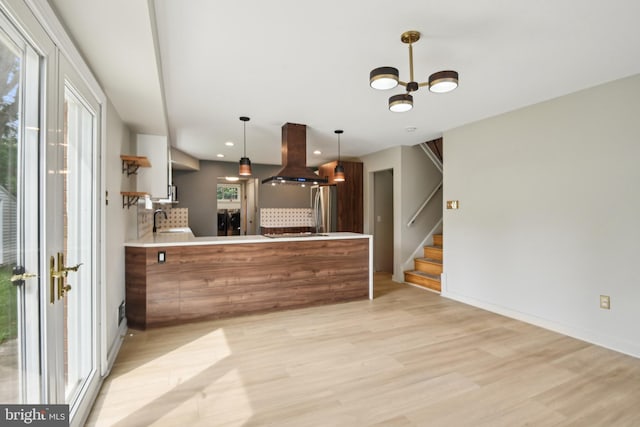 906 N Belgrade Rd, Silver Spring, MD 20902 - kitchen featuring island exhaust hood, freestanding refrigerator, light wood-style flooring, healthy amount of natural light, and recessed lighting