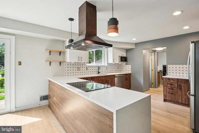 906 N Belgrade Rd, Silver Spring, MD 20902 - kitchen featuring island range hood, appliances with stainless steel finishes, decorative backsplash, light countertops, and recessed lighting