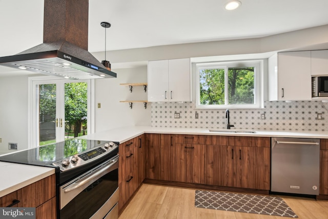 906 N Belgrade Rd, Silver Spring, MD 20902 - kitchen with appliances with stainless steel finishes, a sink, wall chimney range hood, white cabinets, and light countertops