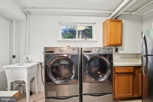 906 N Belgrade Rd, Silver Spring, MD 20902 - laundry area with cabinet space, washer and clothes dryer, and light tile patterned flooring