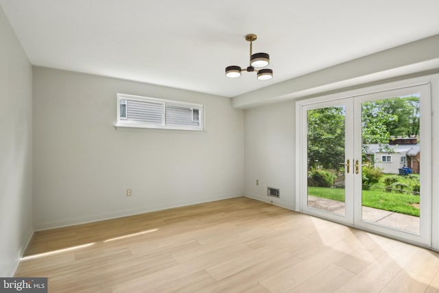 906 N Belgrade Rd, Silver Spring, MD 20902 - unfurnished room featuring light wood-type flooring, a chandelier, and baseboards