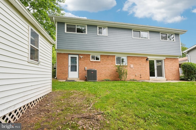 906 N Belgrade Rd, Silver Spring, MD 20902 - back of property featuring brick siding, cooling unit, and a yard