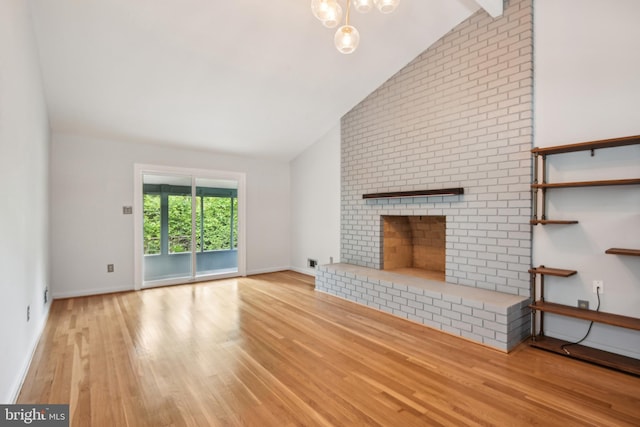 906 N Belgrade Rd, Silver Spring, MD 20902 - unfurnished living room featuring lofted ceiling, wood finished floors, a brick fireplace, and baseboards