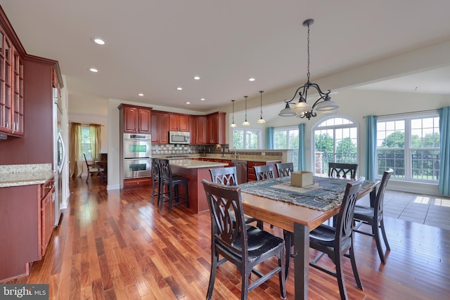 dining space featuring a notable chandelier and dark hardwood / wood-style floors