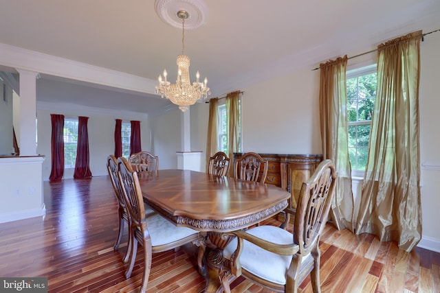 dining space with an inviting chandelier and hardwood / wood-style floors