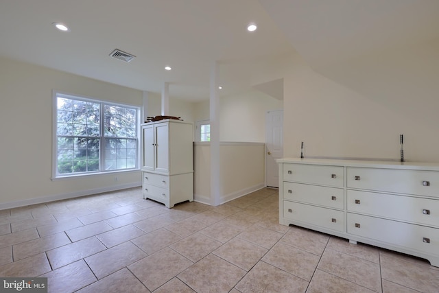 interior space featuring light tile patterned floors and white cabinets