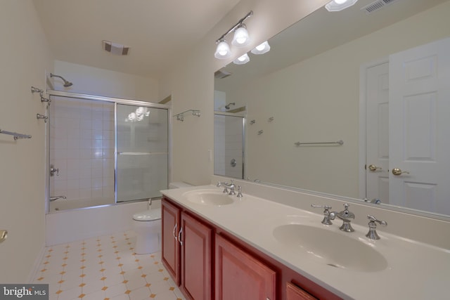 full bathroom with vanity, combined bath / shower with glass door, and toilet