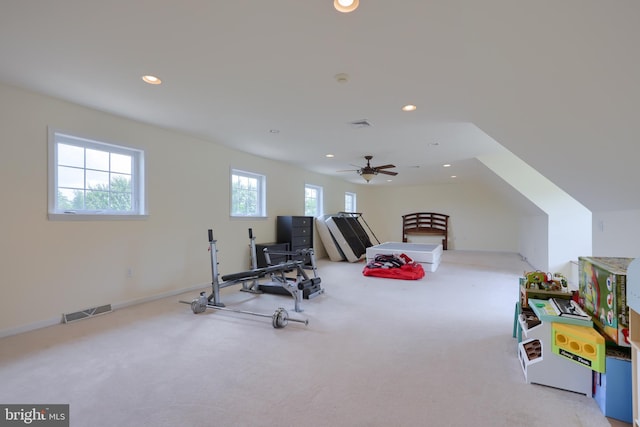 exercise area with light carpet and ceiling fan