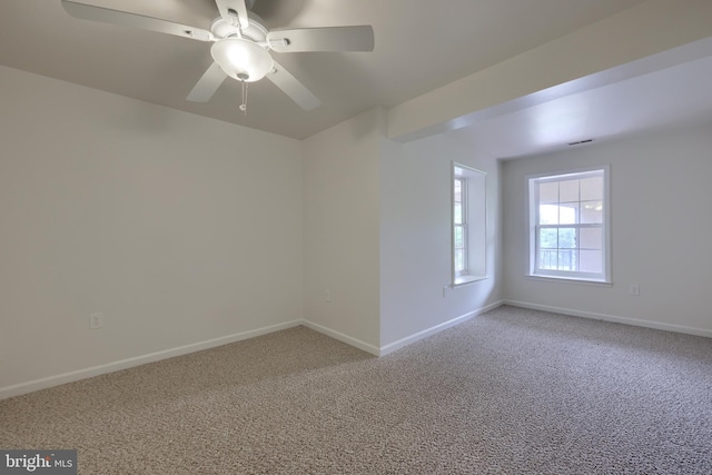 carpeted spare room with ceiling fan