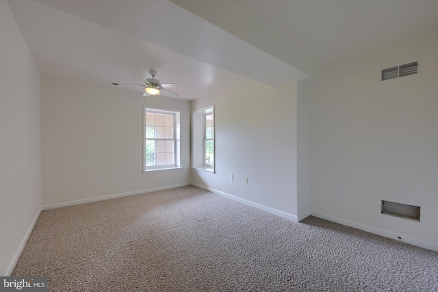 carpeted empty room featuring ceiling fan