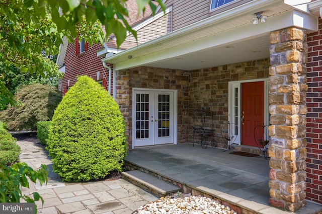 entrance to property with a patio area and french doors