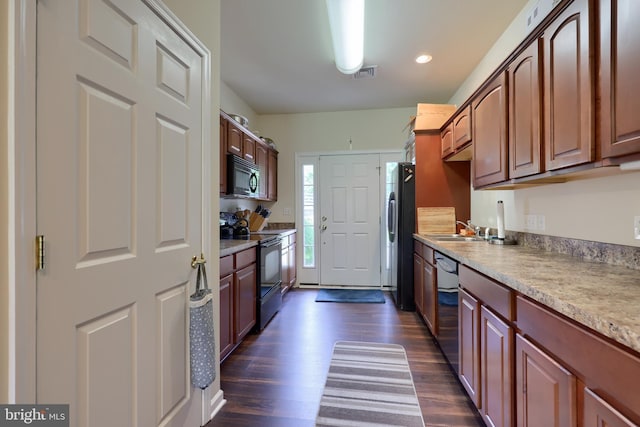 kitchen featuring sink, black appliances, and dark hardwood / wood-style floors