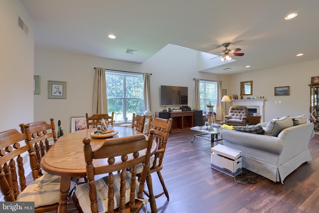 dining area with ceiling fan, a healthy amount of sunlight, and dark hardwood / wood-style flooring