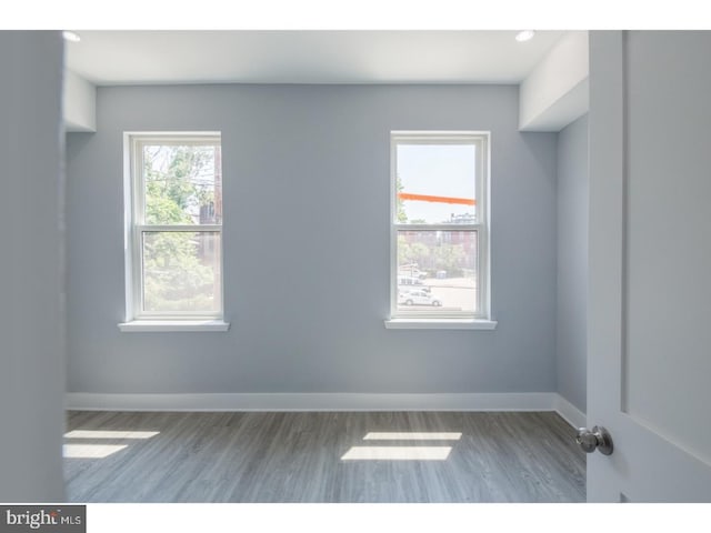 unfurnished room with dark wood-type flooring