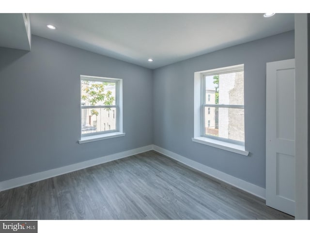 unfurnished room with dark hardwood / wood-style flooring