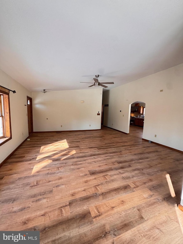 unfurnished living room featuring ceiling fan and hardwood / wood-style floors