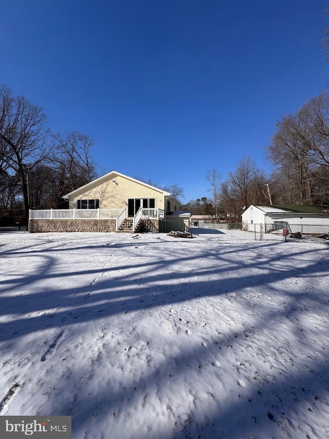 snow covered house featuring a porch