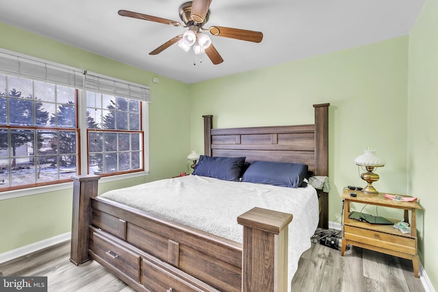 bedroom with ceiling fan and light hardwood / wood-style floors