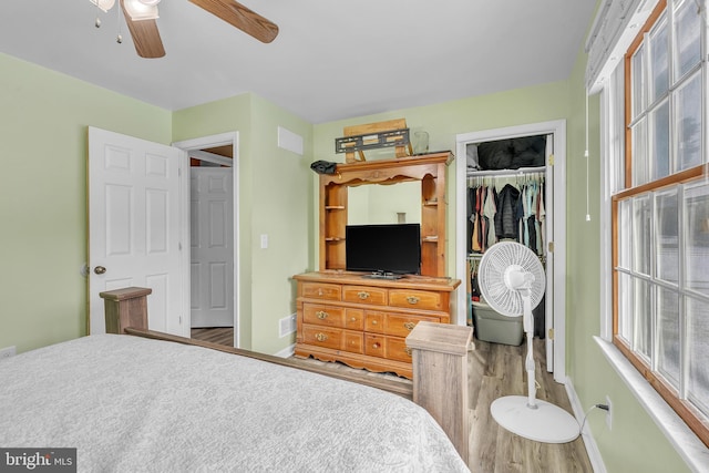 bedroom with ceiling fan and a closet