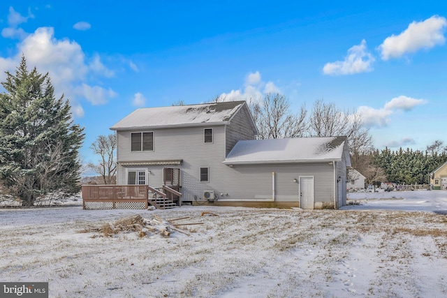 snow covered property featuring a wooden deck